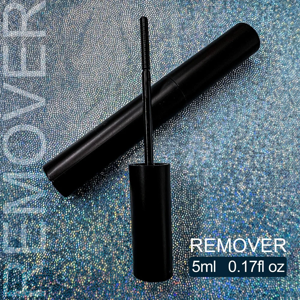 Black mascara tube with brush on a textured blue background